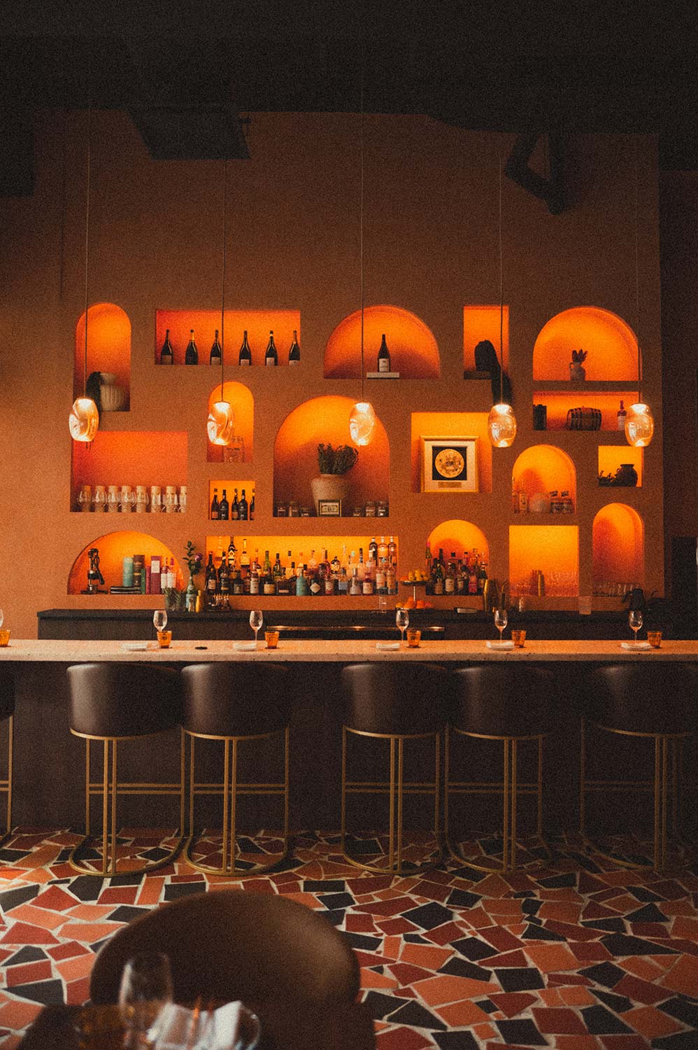 The bar and its warm arched niches